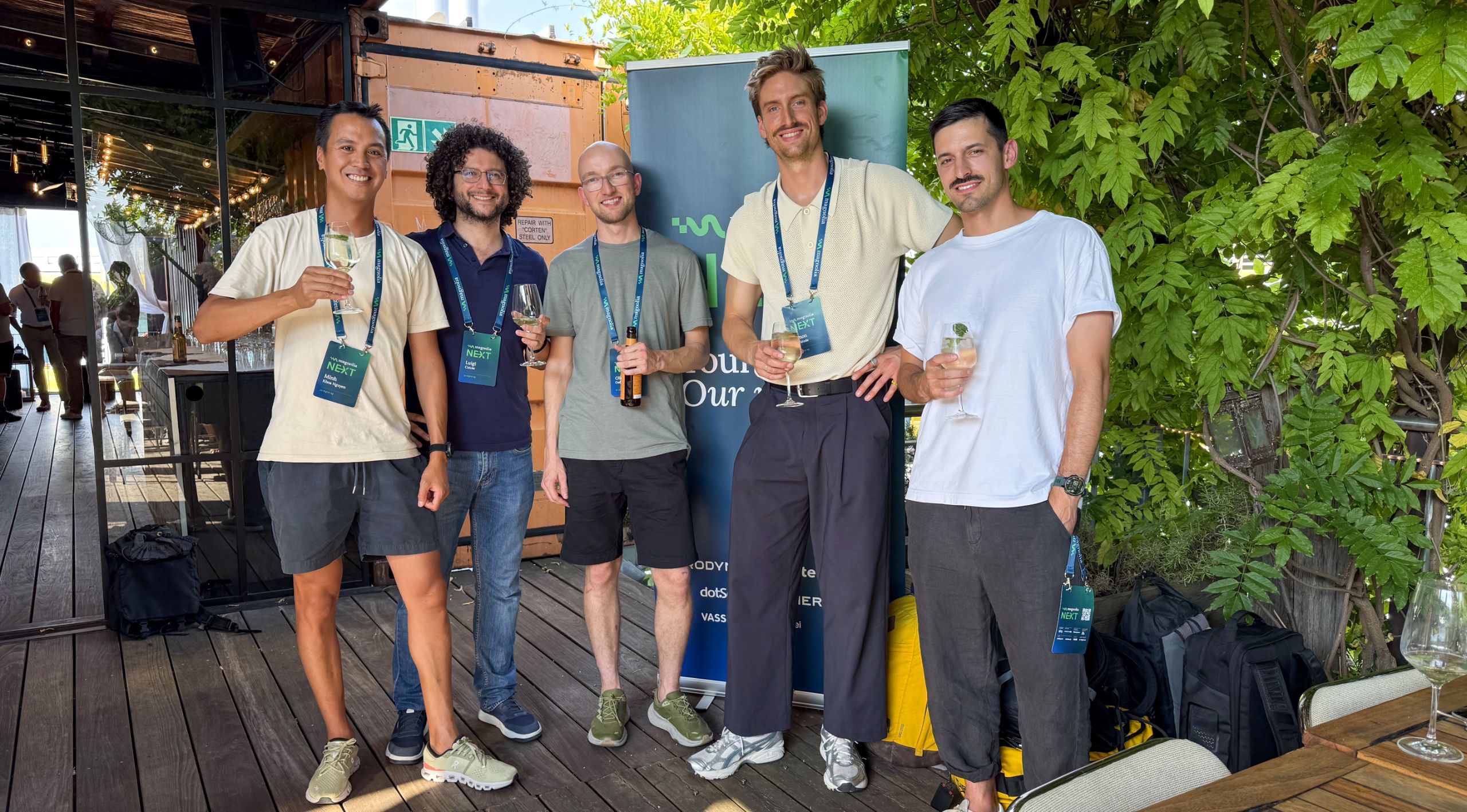 jls-Team beim Apéro vor dem Banner der Magnolia NEXT 2026 in Basel