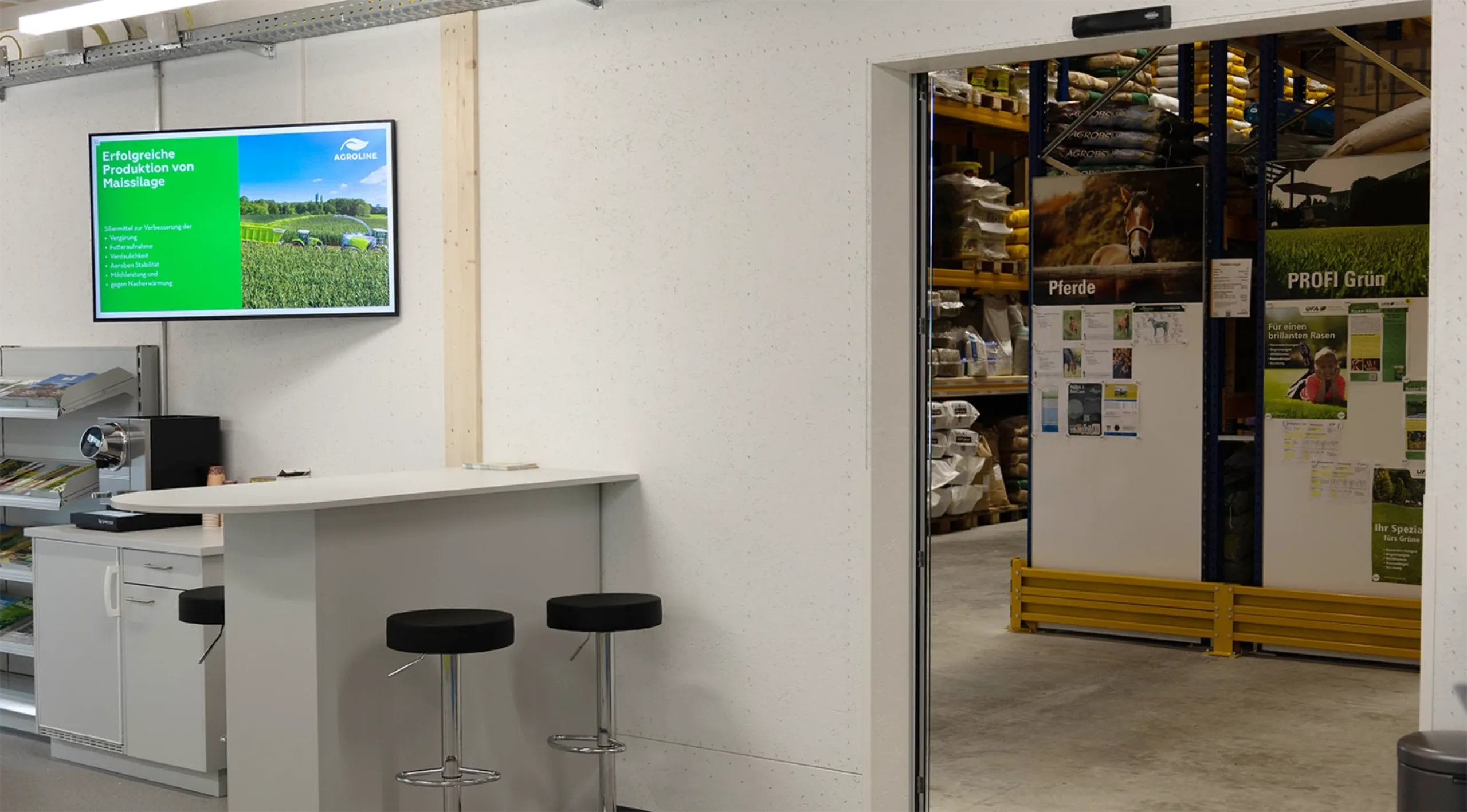 LANDI Agricultural Centre in Niederhasli with digital signage screen in the entrance area, view of the agricultural warehouse
