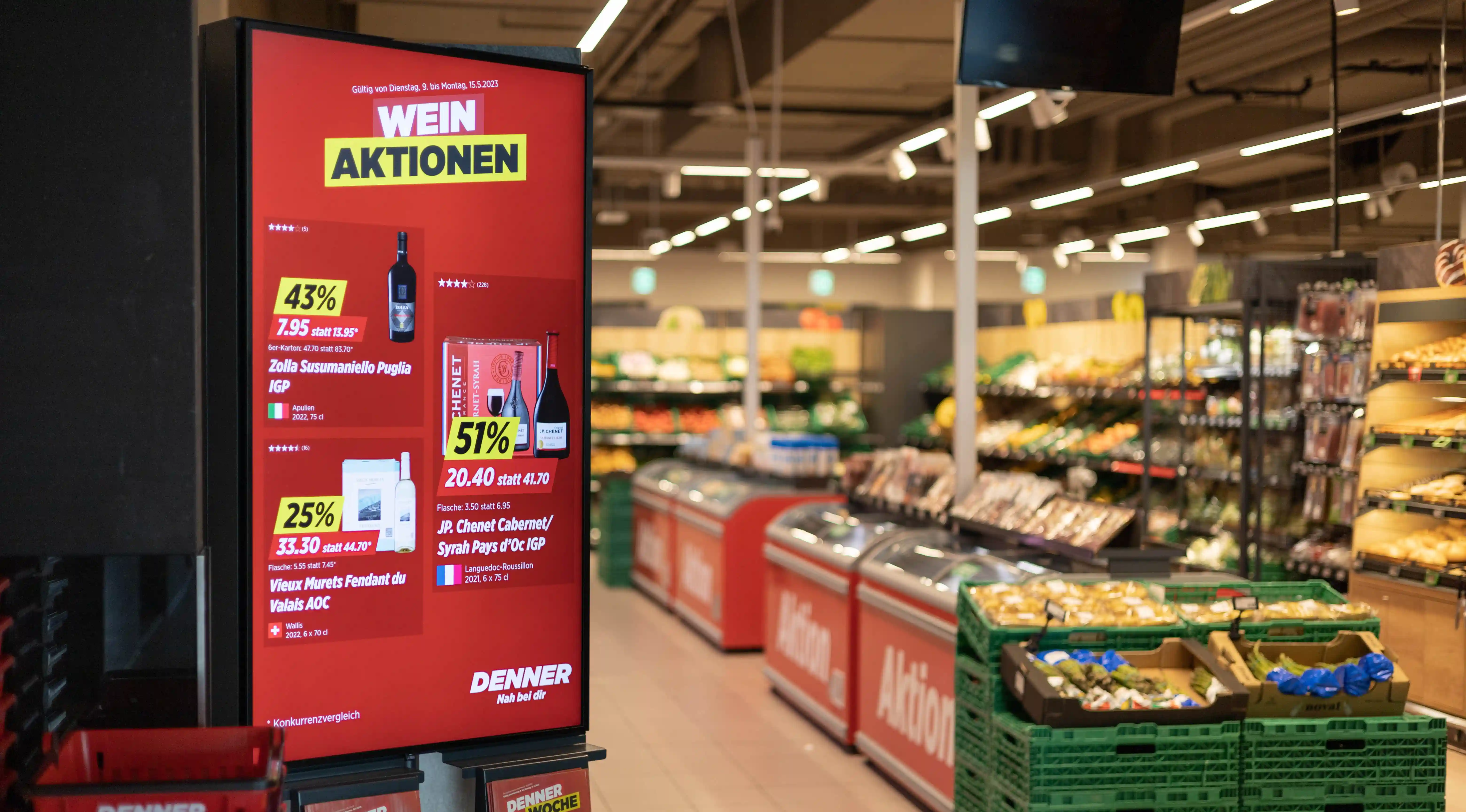jls digital signage in Denner retail: display with wine promotions and pricing for offer communication