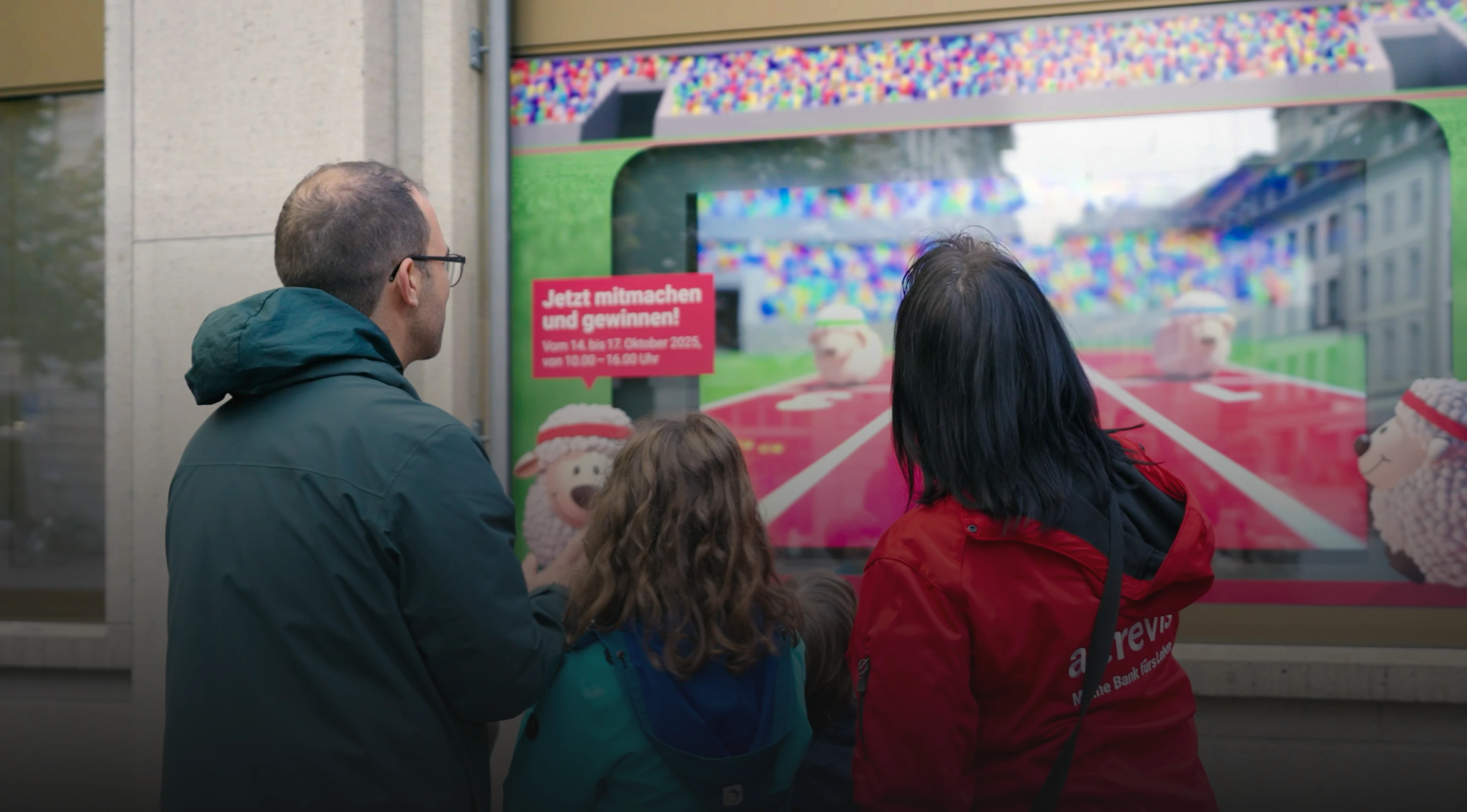 Gamification durch jls: Person startet eine POS-Gamification-Anwendung per Smartphone vor einem Digital-Signage-Screen.