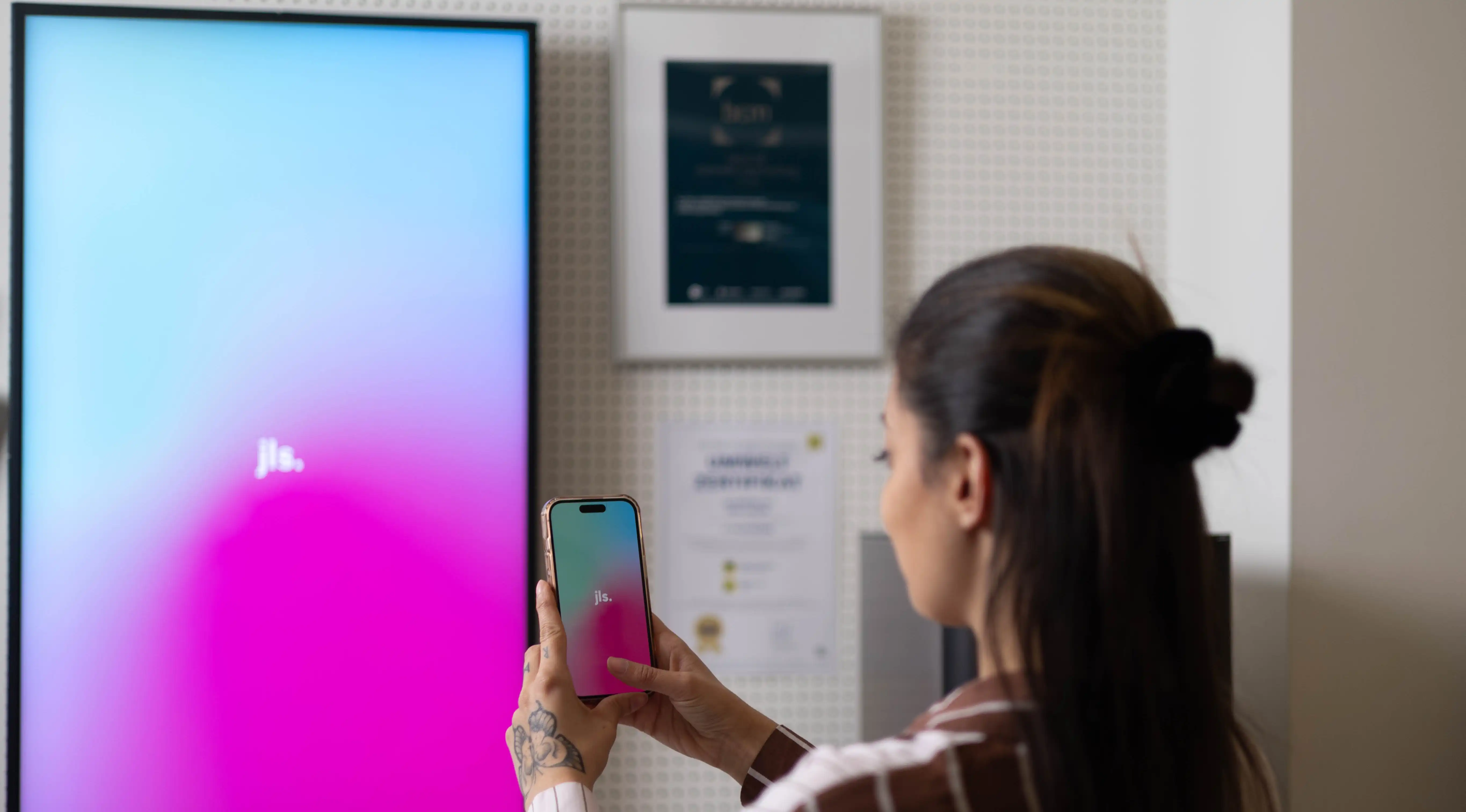 Person interacting with a touchscreen – representing gamified POS experiences created by JLS to increase user engagement.